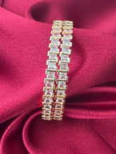 Gold plated bangles intricated with white cubic zirconia stones