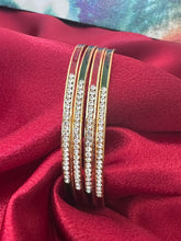 Gold plated bangles intricated with white cubic zirconia stones