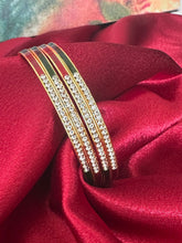 Gold plated bangles intricated with white cubic zirconia stones